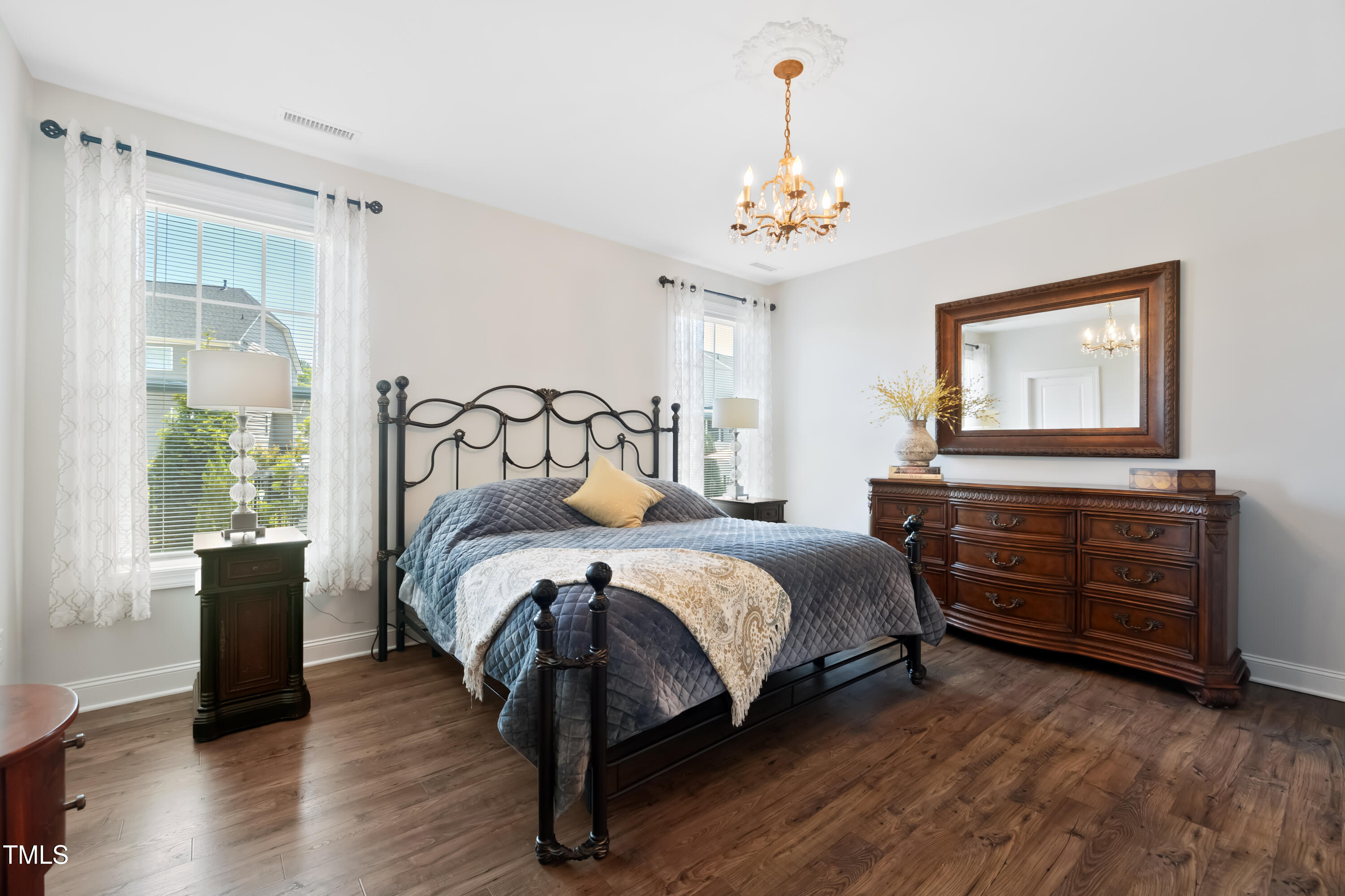 94 Two Creeks Loop Chapel Hill, NC 27517 - Photo 27 of 59 a bedroom with a bed and a chandelier