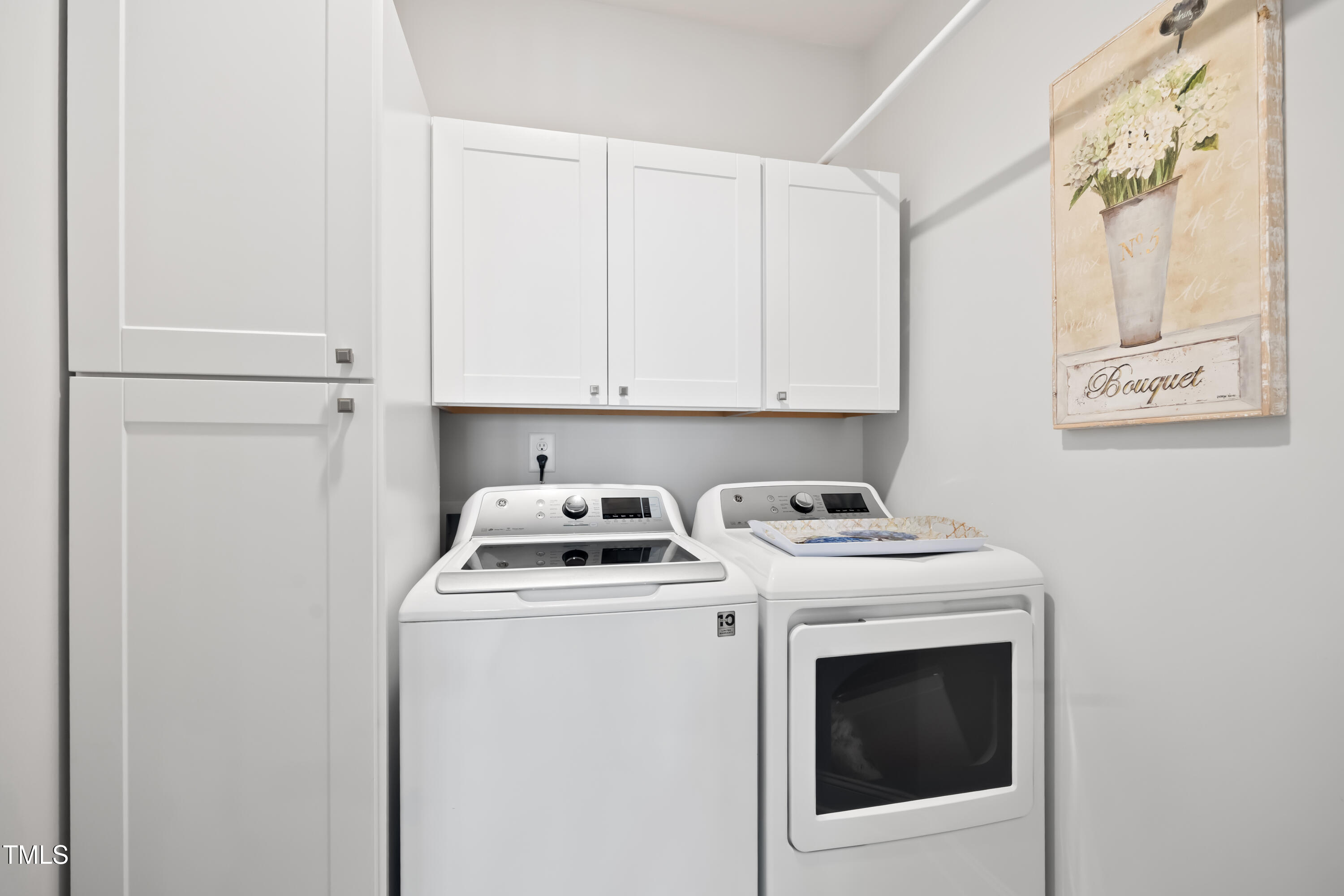 94 Two Creeks Loop Chapel Hill, NC 27517 - Photo 32 of 59 a view of washer and dryer with kitchen in the background