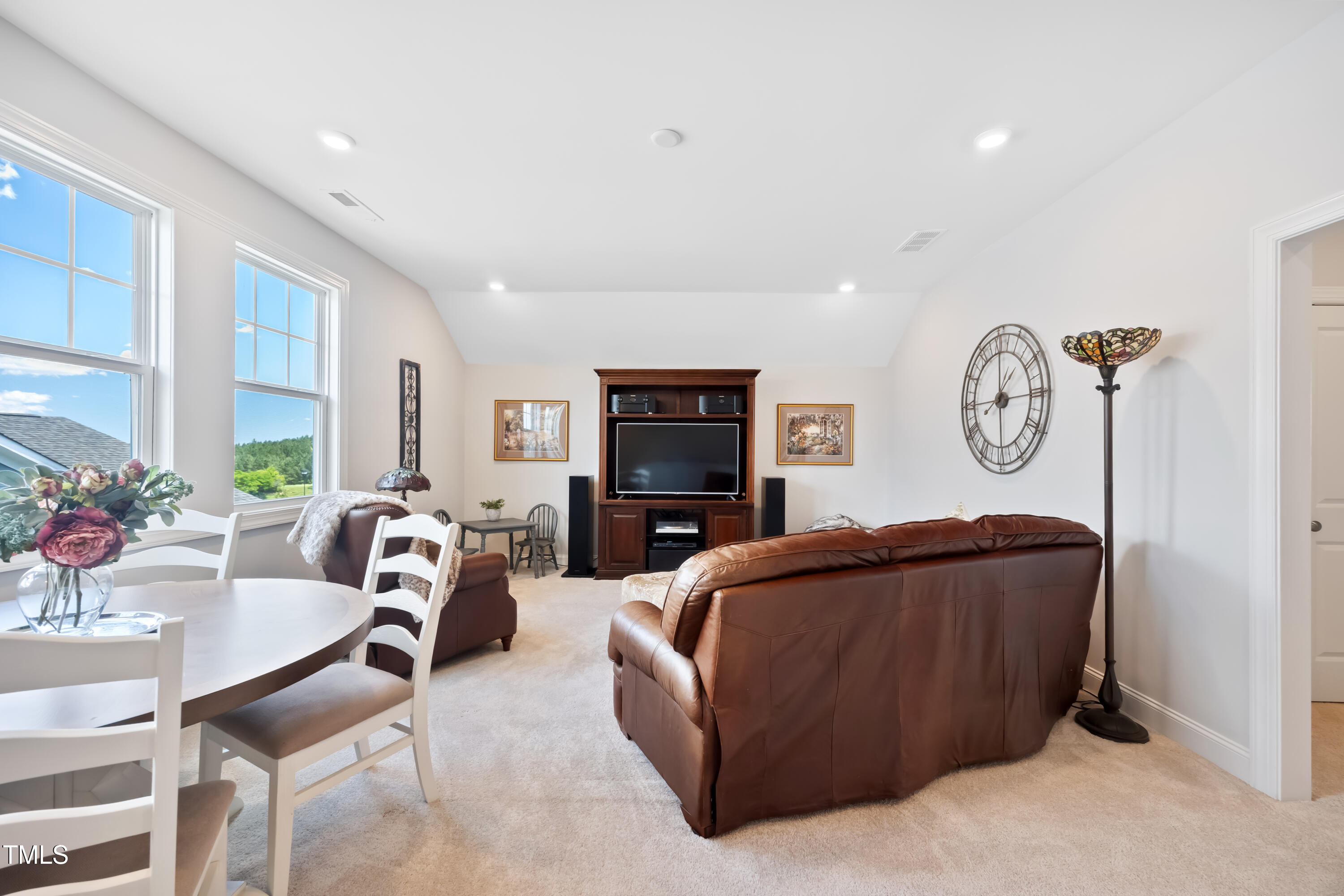 94 Two Creeks Loop Chapel Hill, NC 27517 - Photo 36 of 59 a living room with furniture a clock tv and a large window