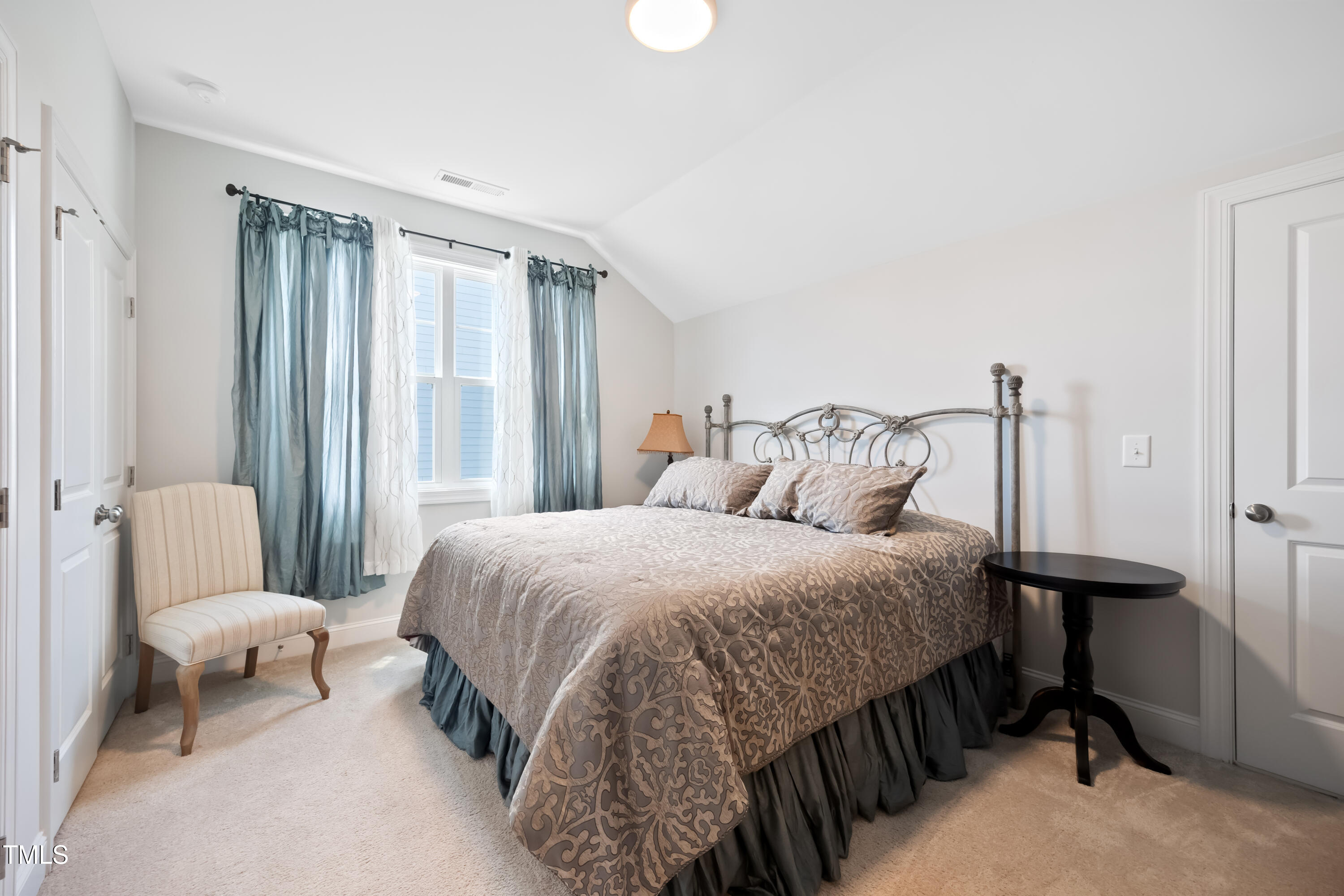 94 Two Creeks Loop Chapel Hill, NC 27517 - Photo 38 of 59 a bedroom with a bed a mirror and a window