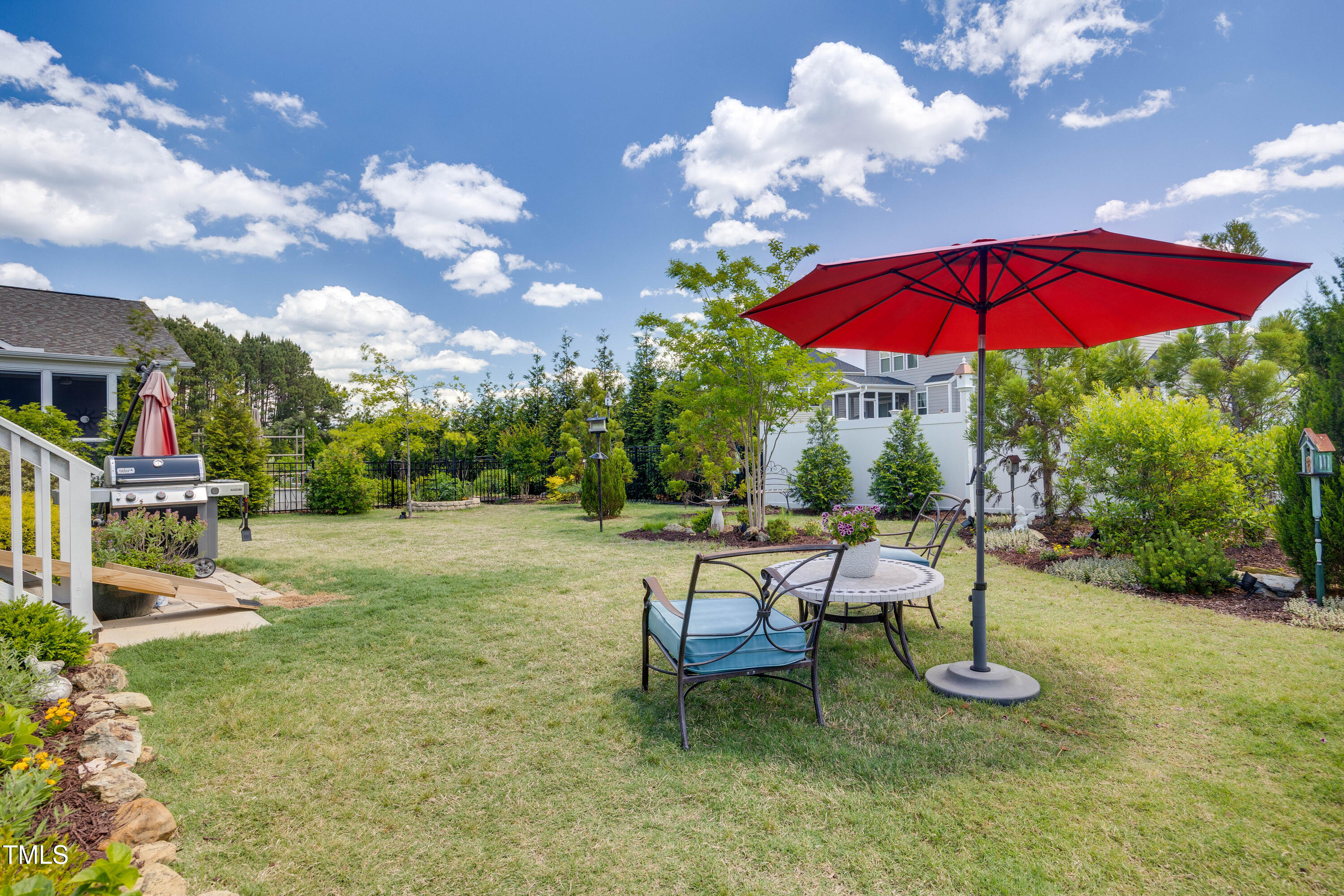 94 Two Creeks Loop Chapel Hill, NC 27517 - Photo 42 of 59 a view of a house with backyard sitting area and garden