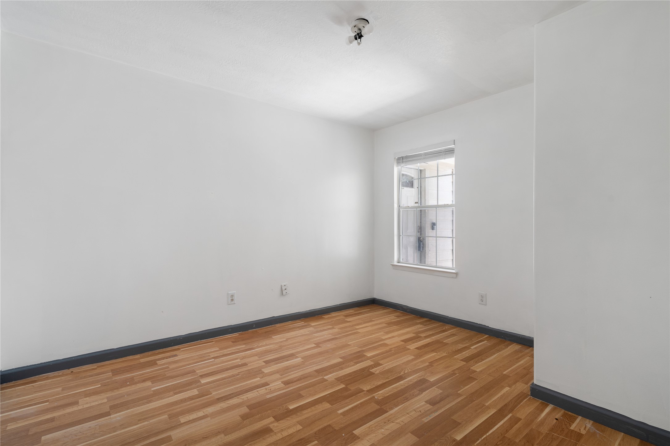 19431 River Bottom Road Katy, TX 77449 - Photo 11 of 12 a view of empty room with wooden floor and fan