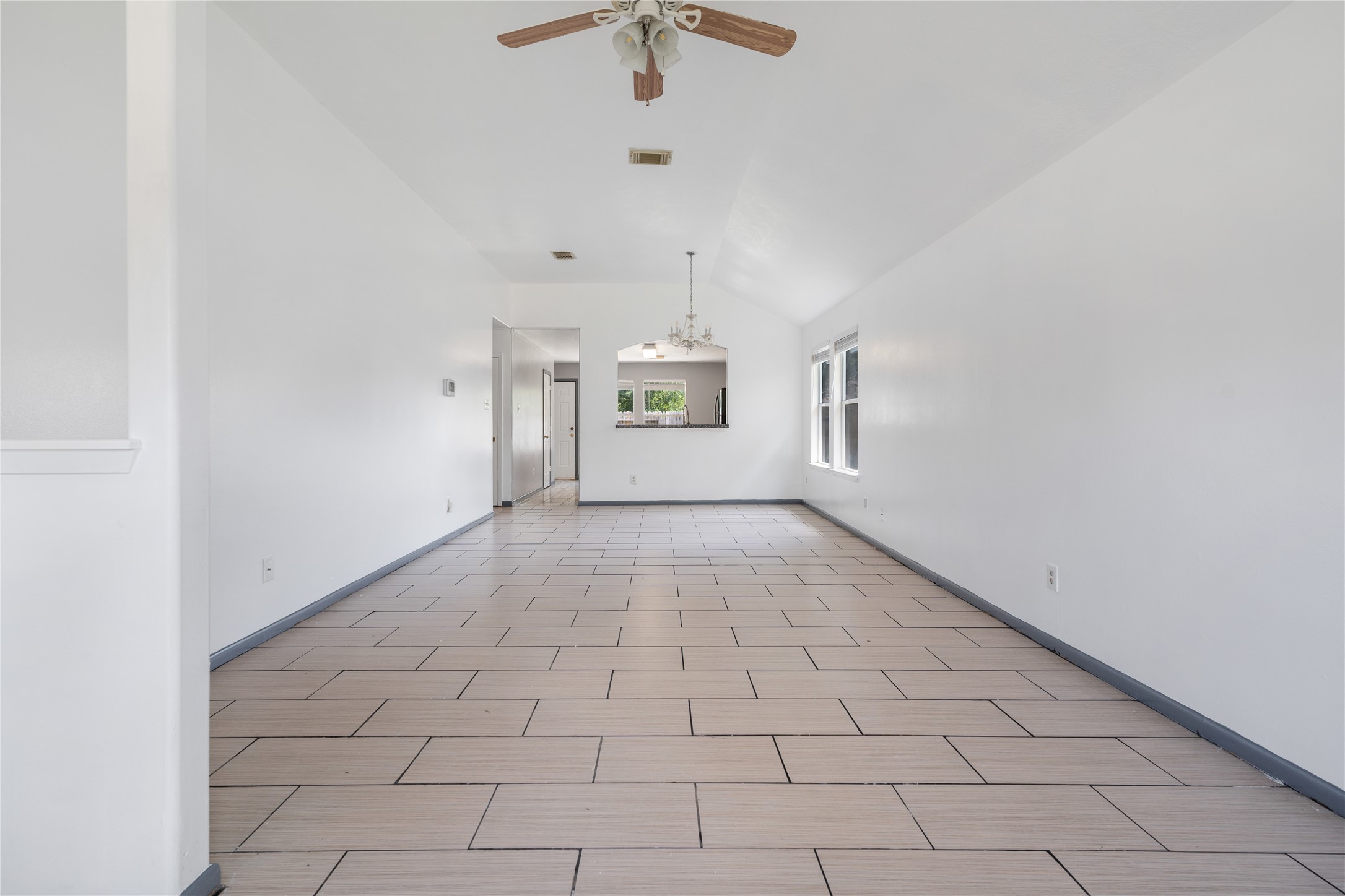 19431 River Bottom Road Katy, TX 77449 - Photo 2 of 12 en empty room with white walls and ceiling fan