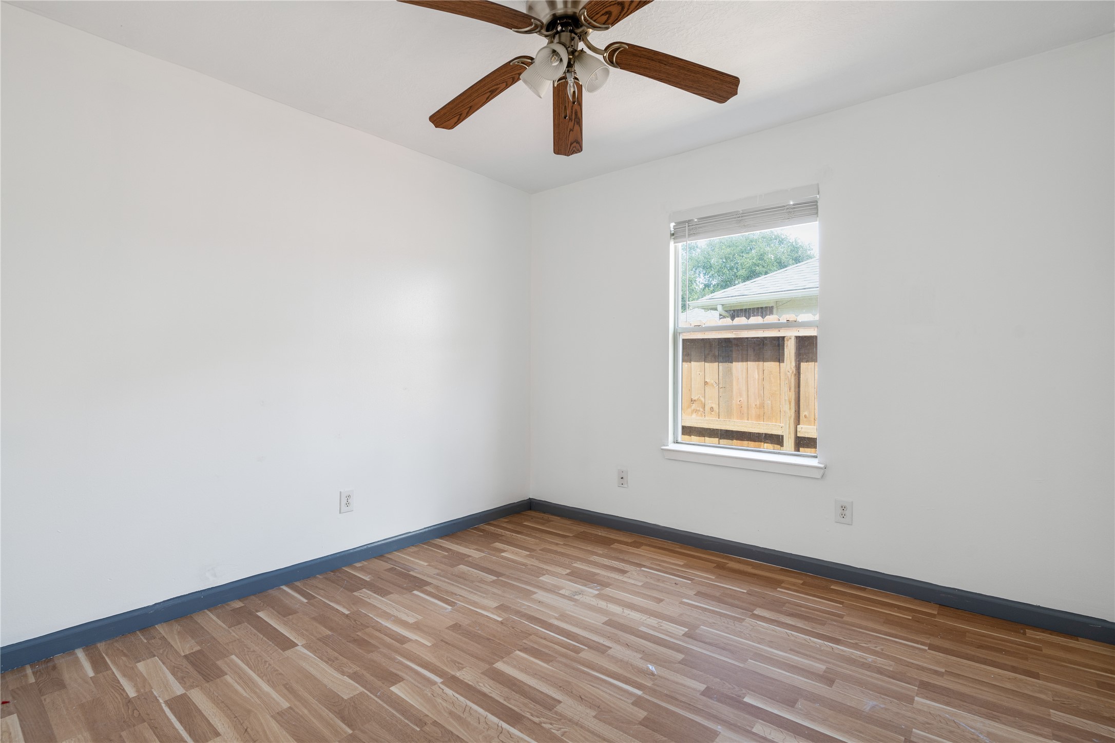 19431 River Bottom Road Katy, TX 77449 - Photo 10 of 12 an empty room with a window and a fan