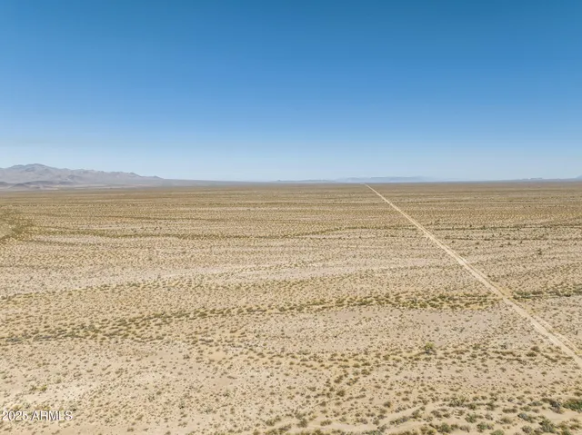 a view of an ocean beach and mountain