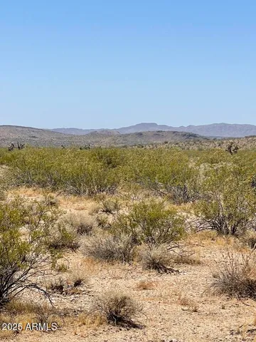 a view of a large mountain with mountains in the background