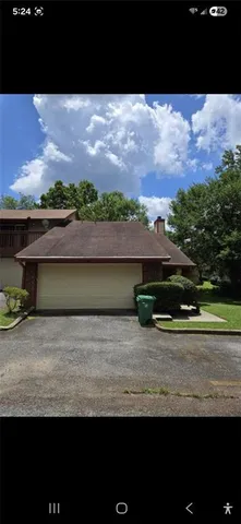 a view of a house with a yard and a garden
