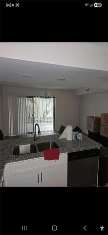 a kitchen with a sink and a stove