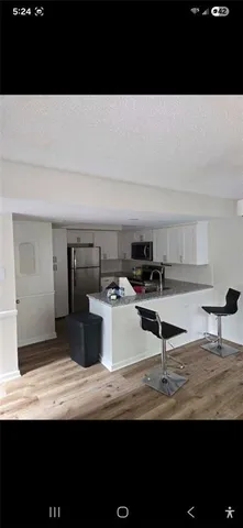 a view of a kitchen with kitchen island sink and stove
