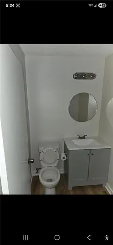 a bathroom with a toilet a sink and mirror
