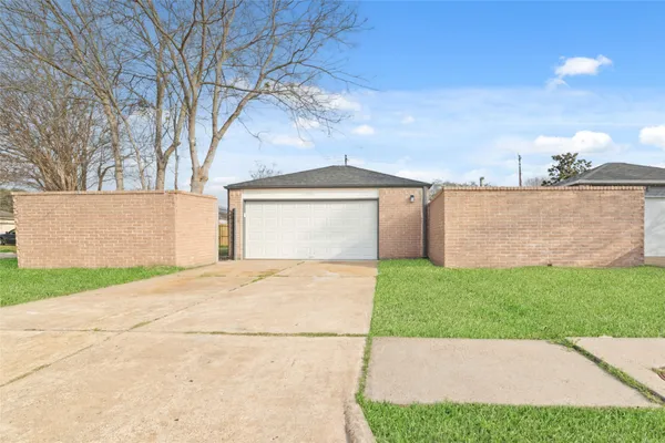 a view of backyard of house with green space