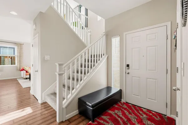 a view of entryway and hall with wooden floor