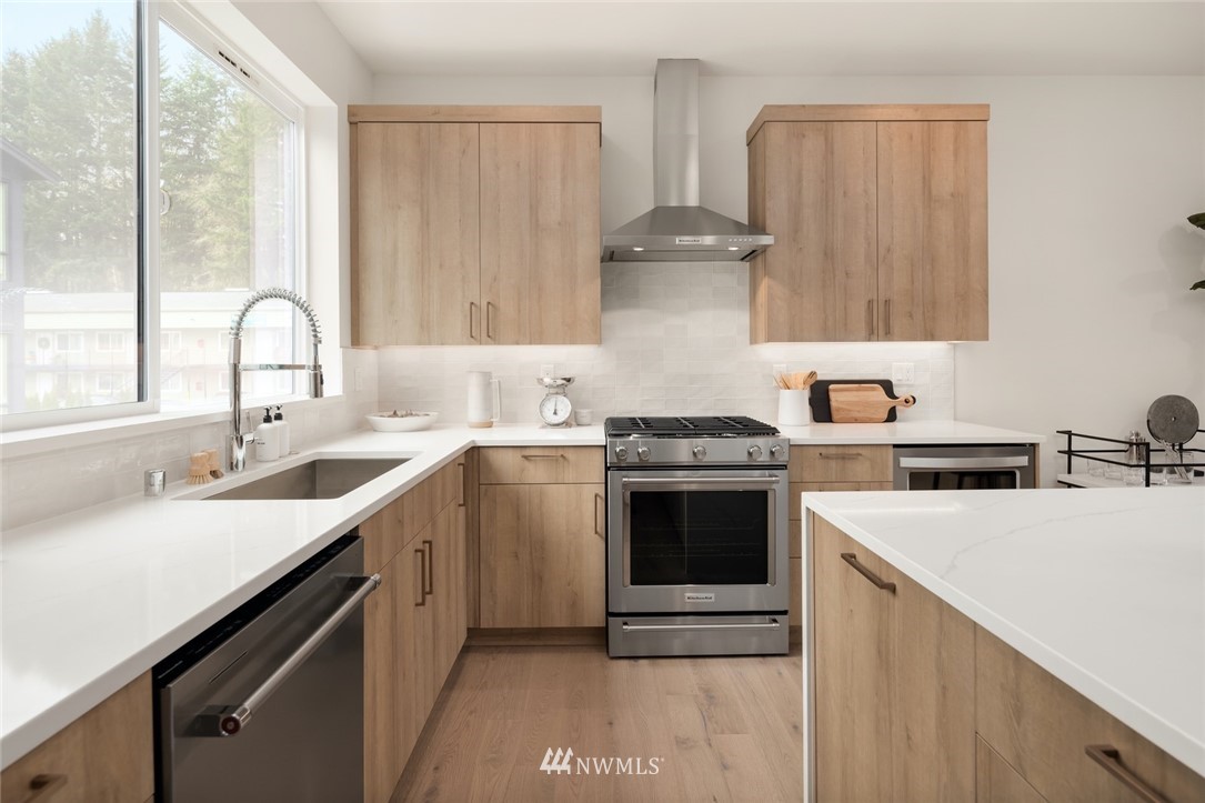 18517 96th Drive Northeast, Unit A Bothell, WA 98011 - Photo 12 of 31 a kitchen with a sink stove and cabinets