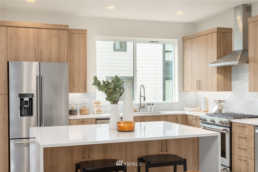 18517 96th Drive Northeast, Unit A Bothell, WA 98011 - Photo 13 of 31 a kitchen with stainless steel appliances a sink and a refrigerator