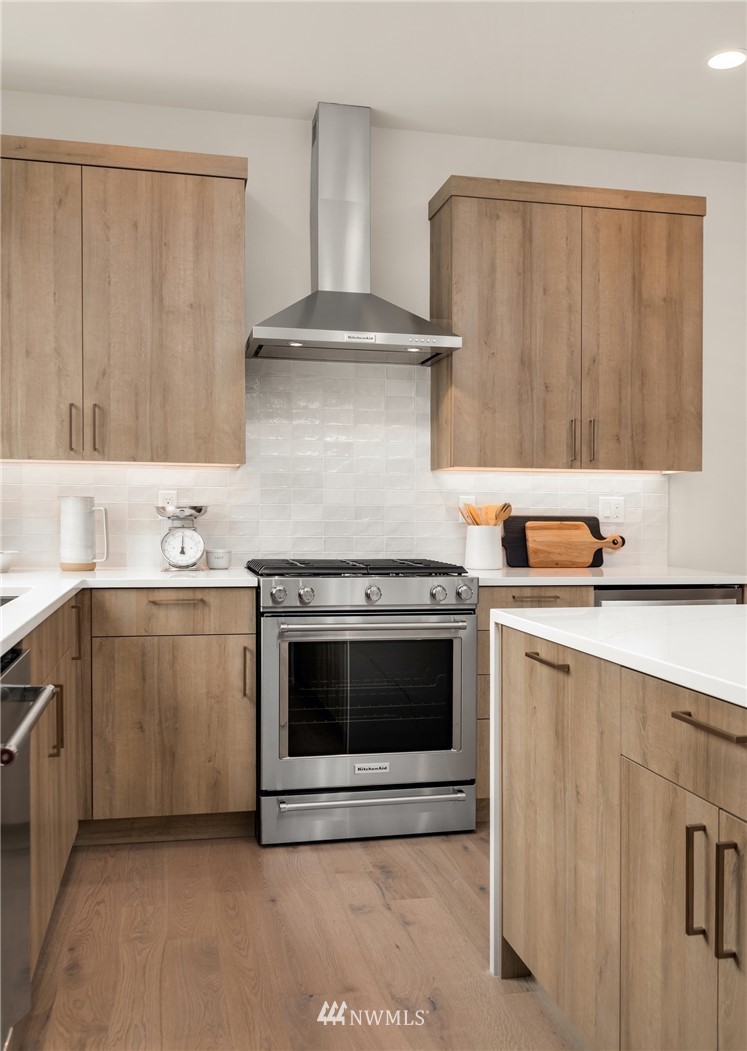 18517 96th Drive Northeast, Unit A Bothell, WA 98011 - Photo 14 of 31 a kitchen with stainless steel appliances granite countertop a sink and a stove