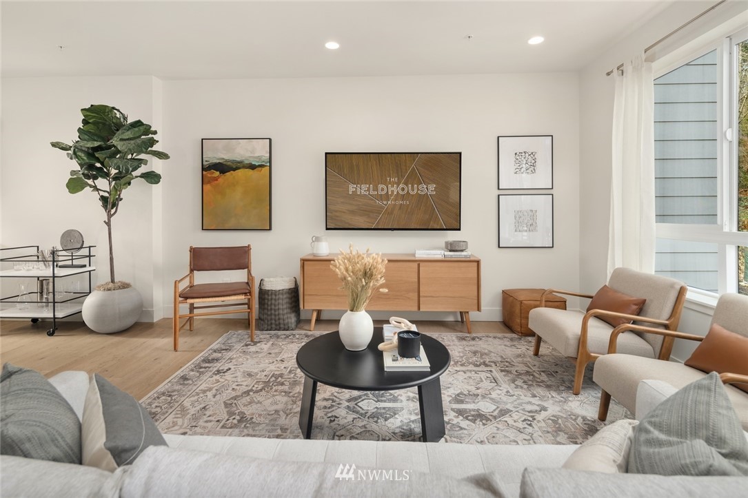 18517 96th Drive Northeast, Unit A Bothell, WA 98011 - Photo 17 of 31 a living room with furniture a rug and a potted plant