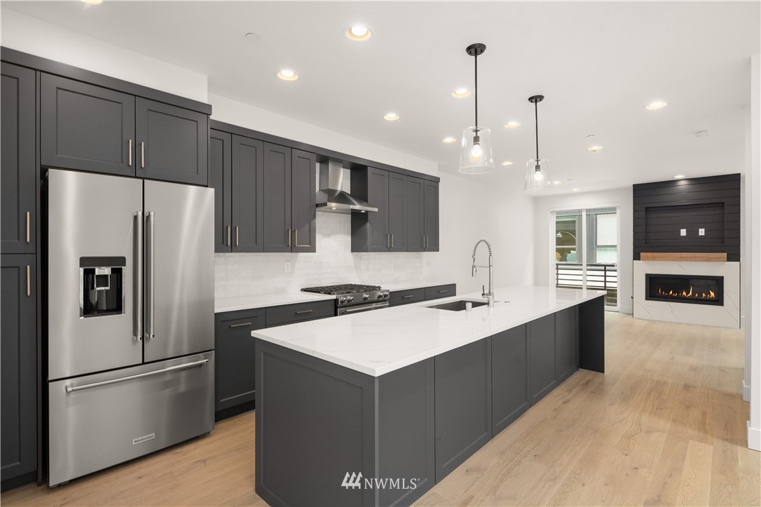 18517 96th Drive Northeast, Unit A Bothell, WA 98011 - Photo 2 of 31 a kitchen with stainless steel appliances a refrigerator and a stove top oven