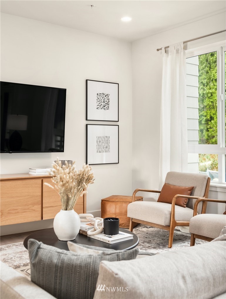 18517 96th Drive Northeast, Unit A Bothell, WA 98011 - Photo 22 of 31 a living room with furniture and a flat screen tv