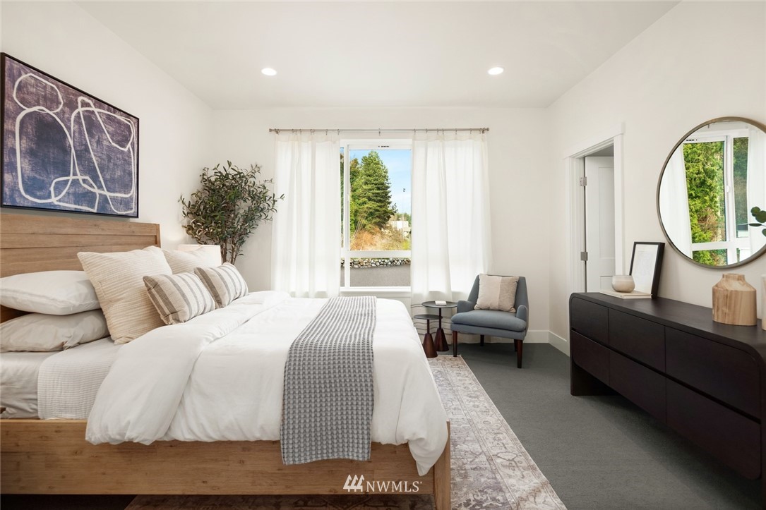 18517 96th Drive Northeast, Unit A Bothell, WA 98011 - Photo 23 of 31 a bedroom with a large bed and a window
