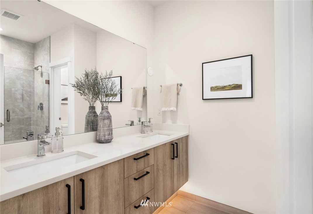 18517 96th Drive Northeast, Unit A Bothell, WA 98011 - Photo 24 of 31 a bathroom with double vanity and a mirror