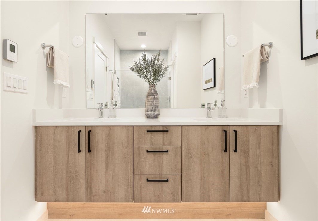 18517 96th Drive Northeast, Unit A Bothell, WA 98011 - Photo 25 of 31 a bathroom with a double vanity sink and mirror