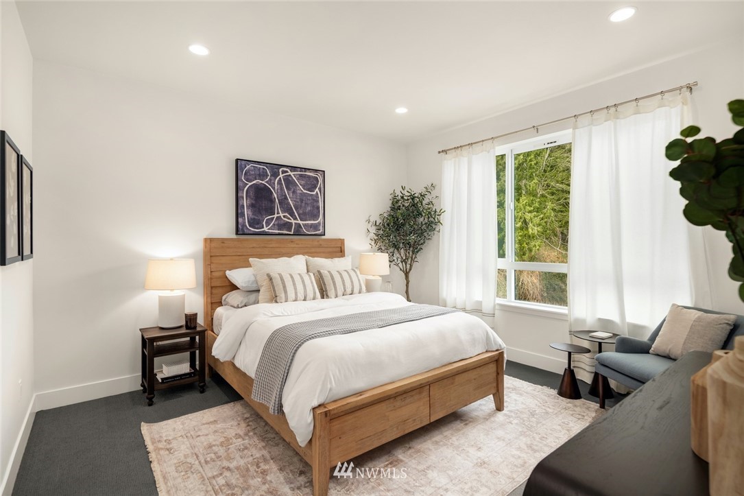 18517 96th Drive Northeast, Unit A Bothell, WA 98011 - Photo 26 of 31 a bedroom with bed and a large window