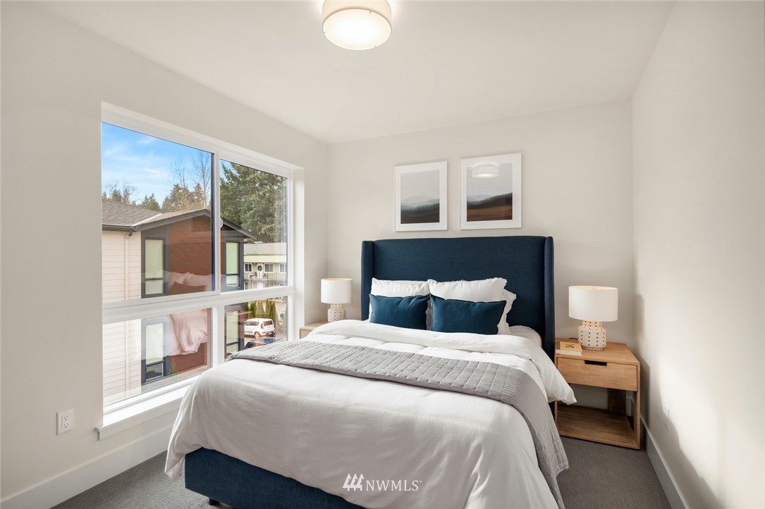 18517 96th Drive Northeast, Unit A Bothell, WA 98011 - Photo 27 of 31 a bedroom with a large bed and a window