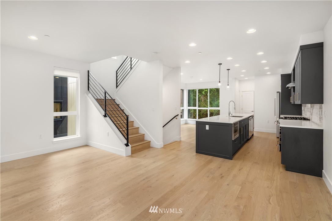 18517 96th Drive Northeast, Unit A Bothell, WA 98011 - Photo 4 of 31 a living room with furniture and a flat screen tv