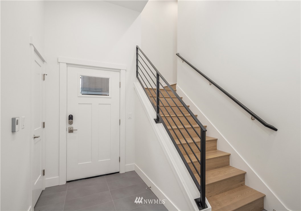 18517 96th Drive Northeast, Unit A Bothell, WA 98011 - Photo 6 of 31 a view of staircase with wooden floor and white walls