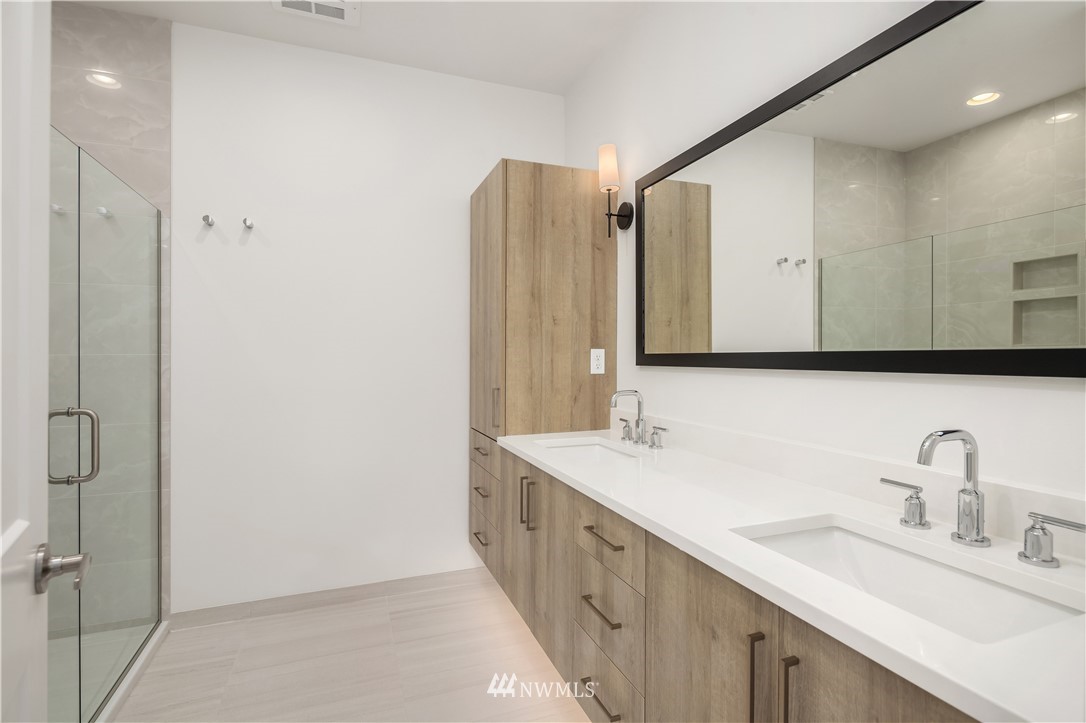 18517 96th Drive Northeast, Unit A Bothell, WA 98011 - Photo 7 of 31 a bathroom with a double vanity sink mirror and double
