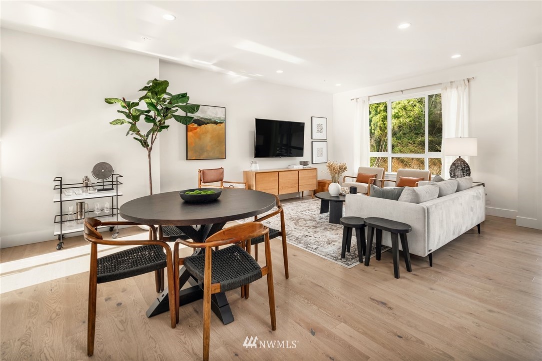 18517 96th Drive Northeast, Unit A Bothell, WA 98011 - Photo 8 of 31 a living room with furniture potted plant and a flat screen tv