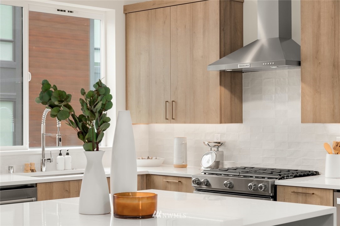 18517 96th Drive Northeast, Unit A Bothell, WA 98011 - Photo 10 of 31 a kitchen with stainless steel appliances a white stove top oven and a refrigerator