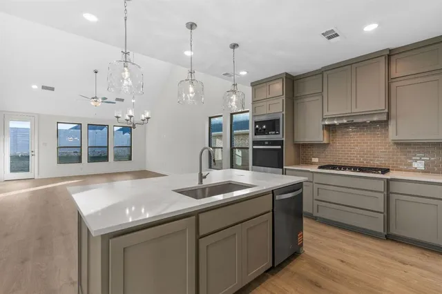 a stove top oven sitting inside of a kitchen