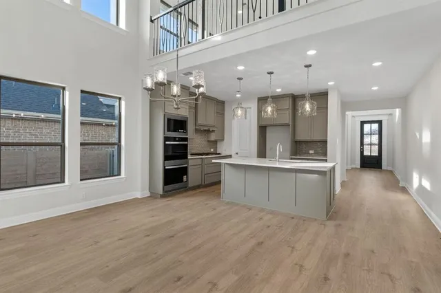 a view of a hallway with wooden floor and entryway