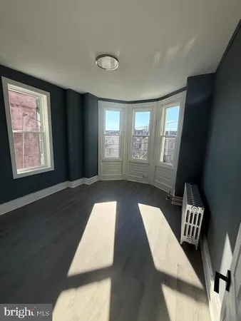 a view of wooden floor and windows in a room