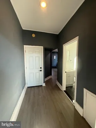 a view of hallway with bathroom