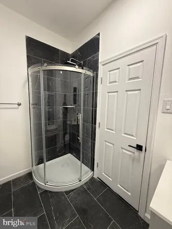 a bathroom with a glass shower door