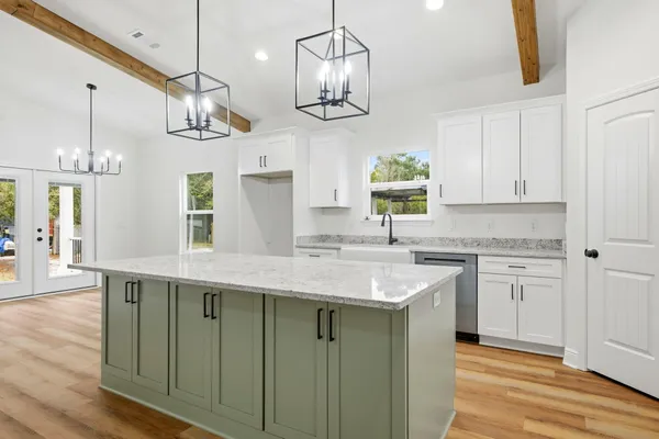 a kitchen with cabinets and wooden floor