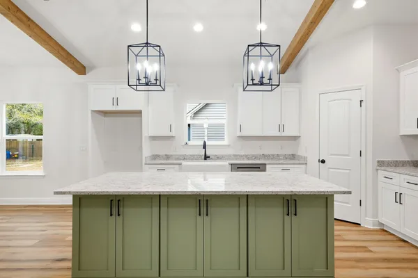 a kitchen with a sink cabinets and window
