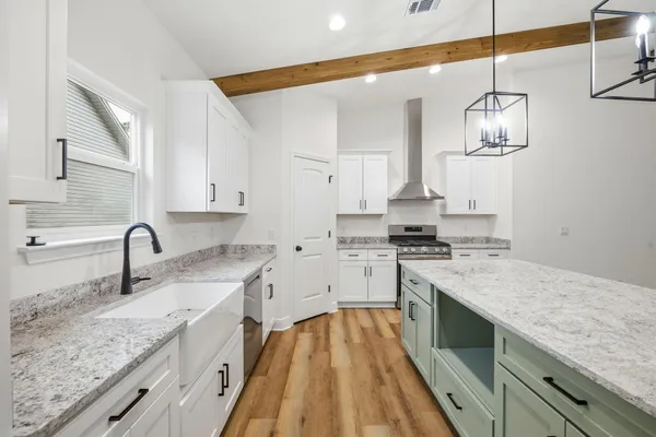 a kitchen with a sink stove and cabinets