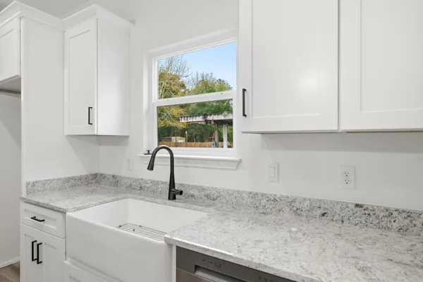 a kitchen with a sink and cabinets