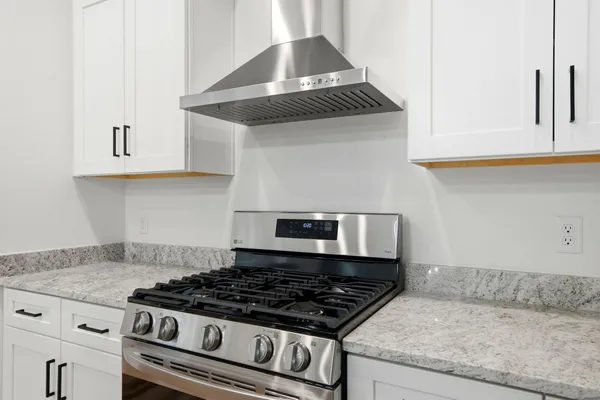 a stove top oven sitting inside of a kitchen