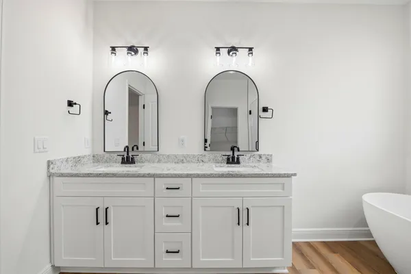 a bathroom with 2 sink and a mirror
