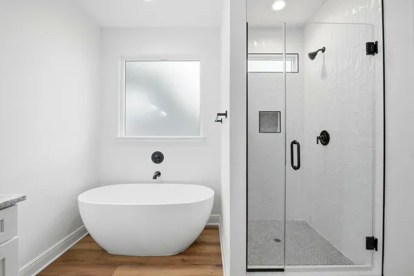 a bathroom with a tub and a shower