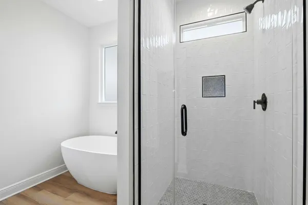 a bathroom with a bathtub and shower