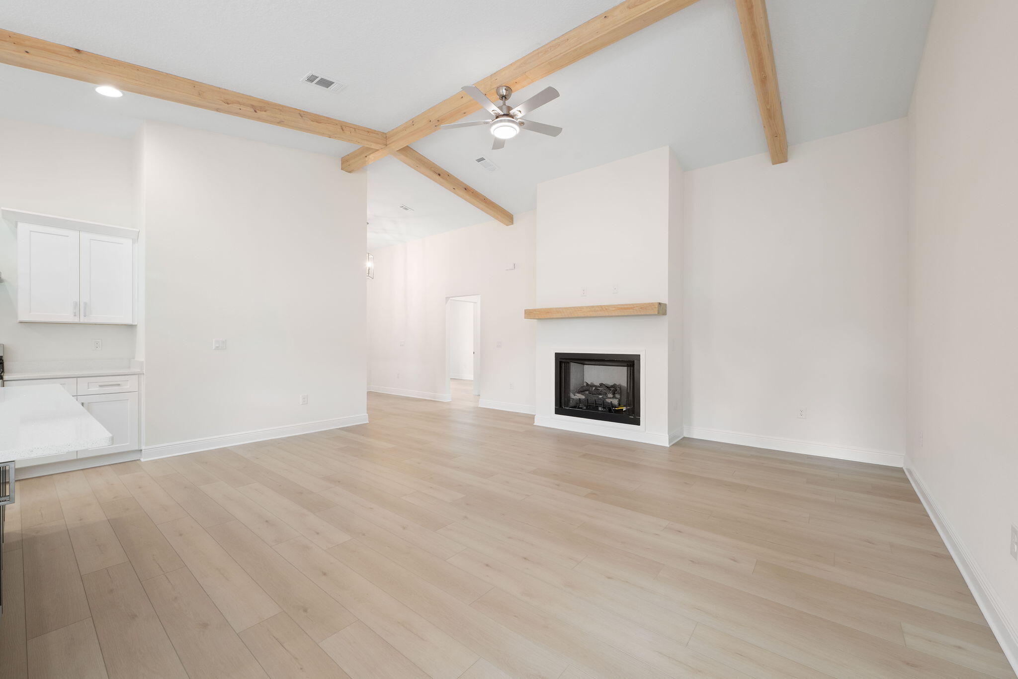 1854 Wheeler Road Gulf Breeze, FL 32563 - Photo 7 of 11 a view of an empty room with wooden floor and a fireplace
