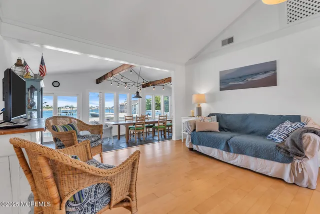a bedroom with a bed and a flat tv screen on the dresser