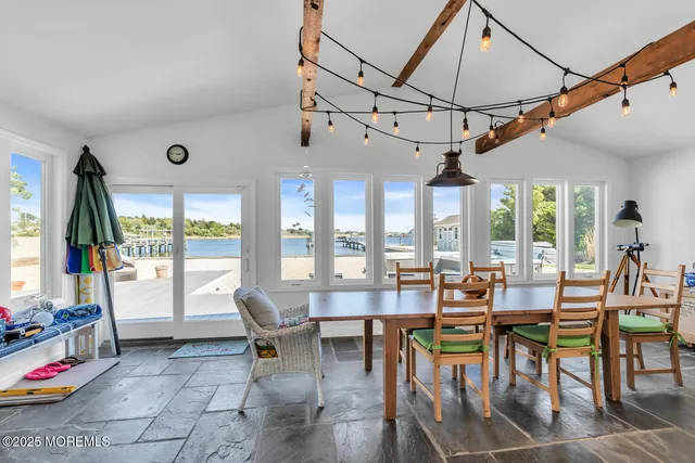 a bathroom with a granite countertop toilet sink and mirror
