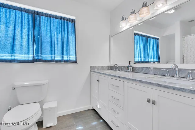 a bedroom with a bed and a flat tv screen on dresser