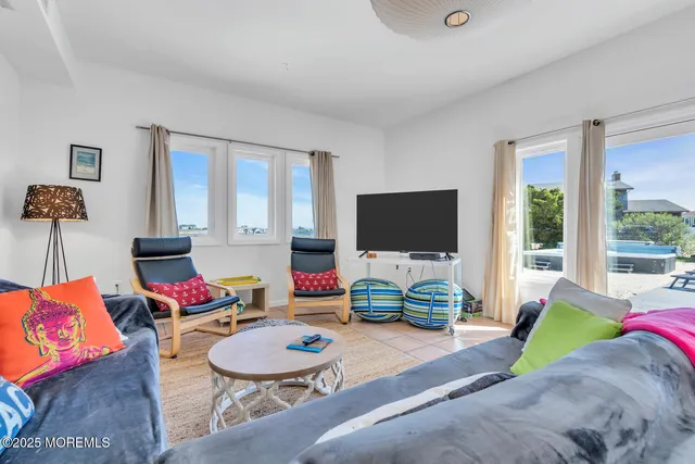 a view of a balcony with chairs and wooden floor